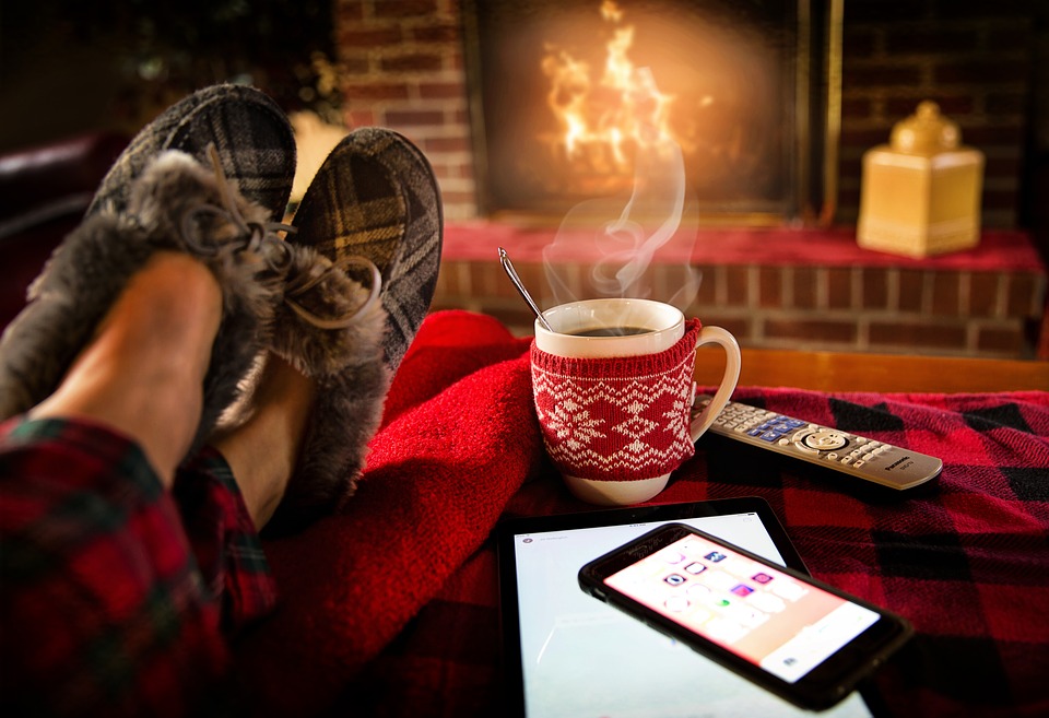 Relaxing by a fire with a hot drink