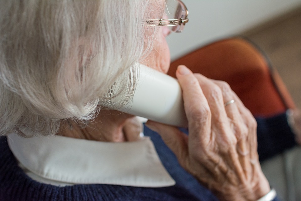 An elderly woman makes a prank call