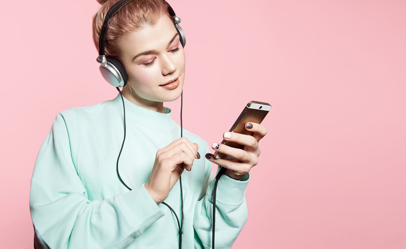 A woman listening to music on a pair of headphones
