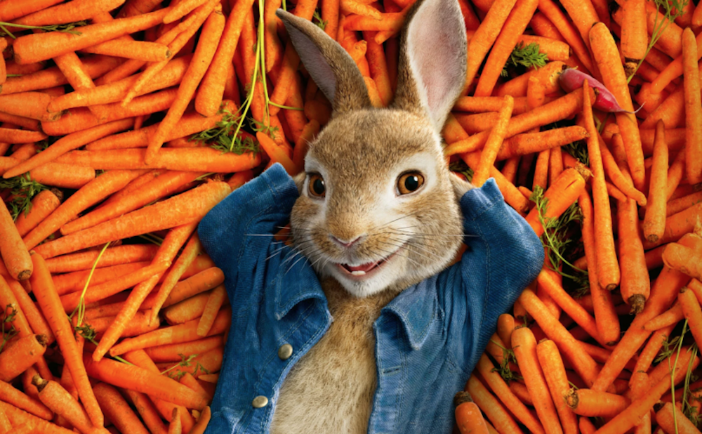 Peter Rabbit lying on a bed of carrots