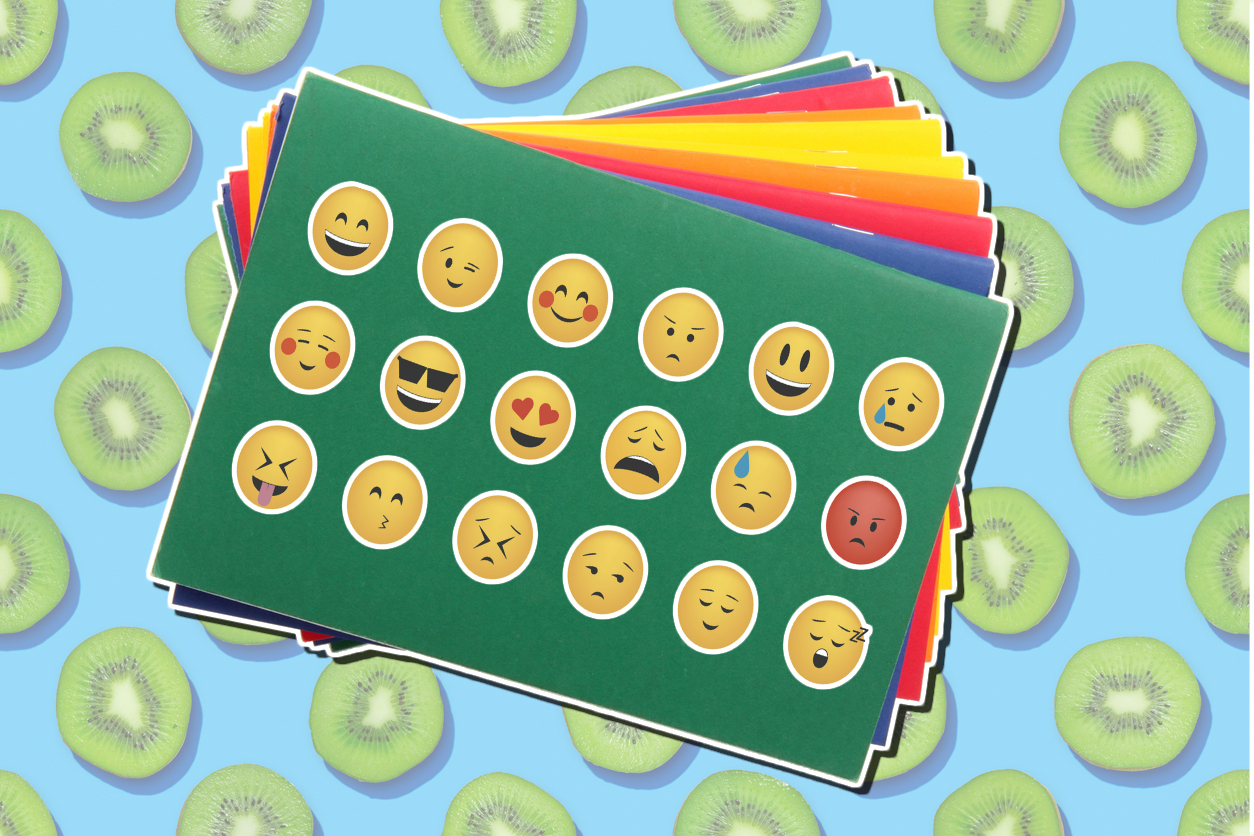 An exercise book covered in emoji stickers