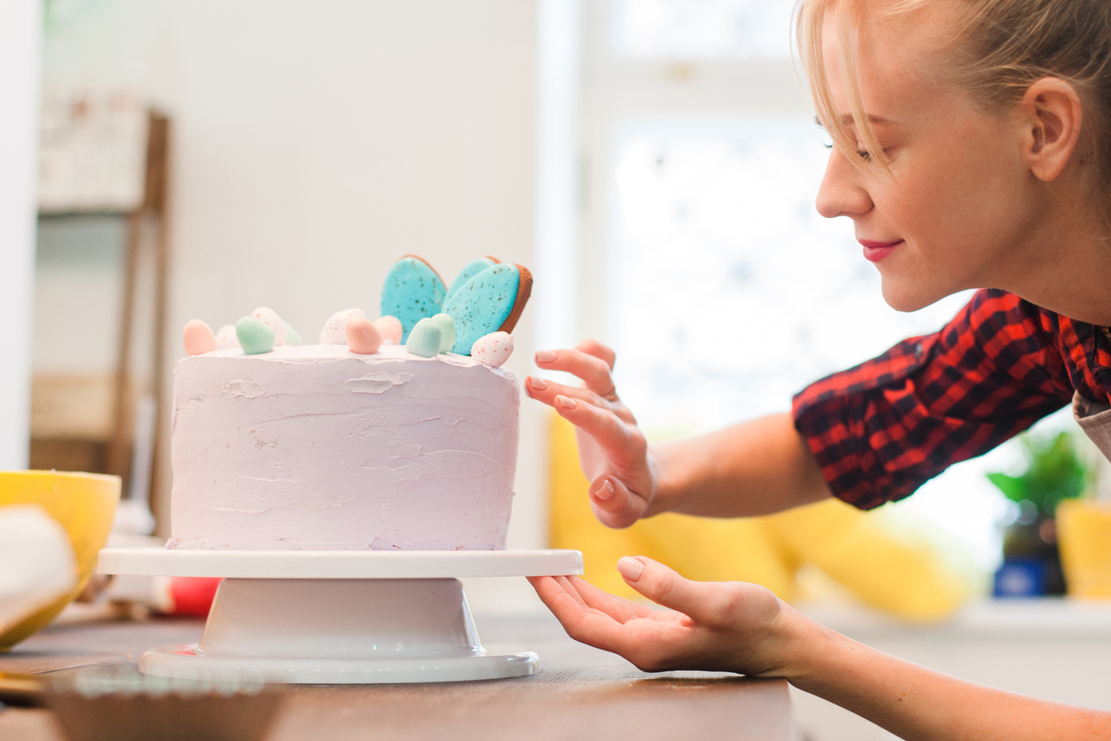 Woman decorates homemade cake