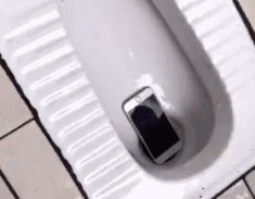 A phone disappears down the toilet