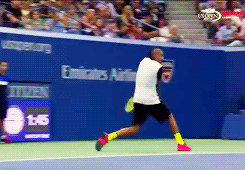 A tennis player throws down his racquet