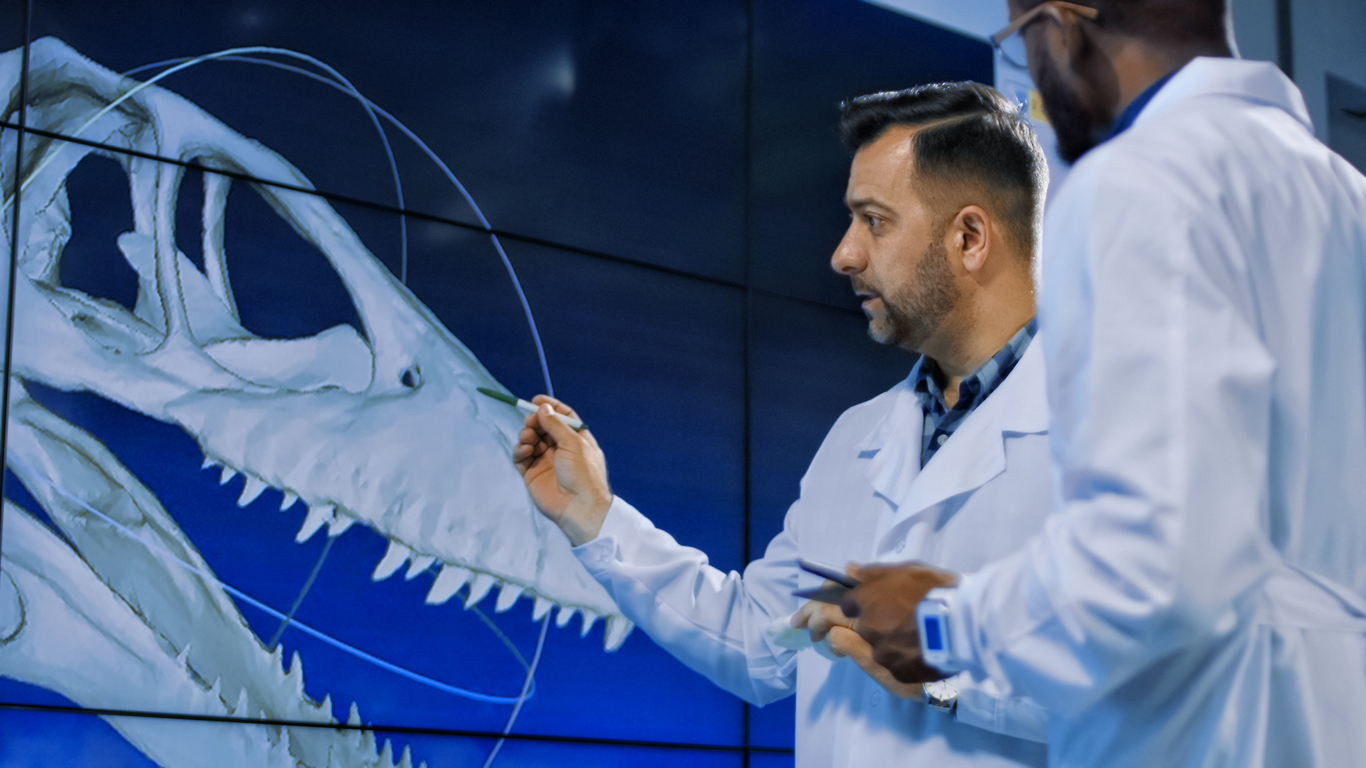 Scientists examine 3D printed model of a dinosaur
