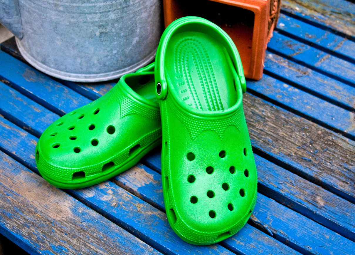 A pair of bright green Crocs clogs