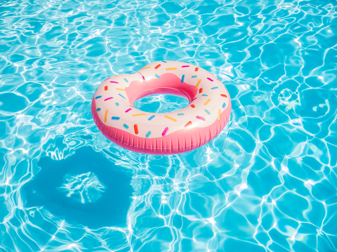 Pink inflatable donut swimming ring in a swimming pool