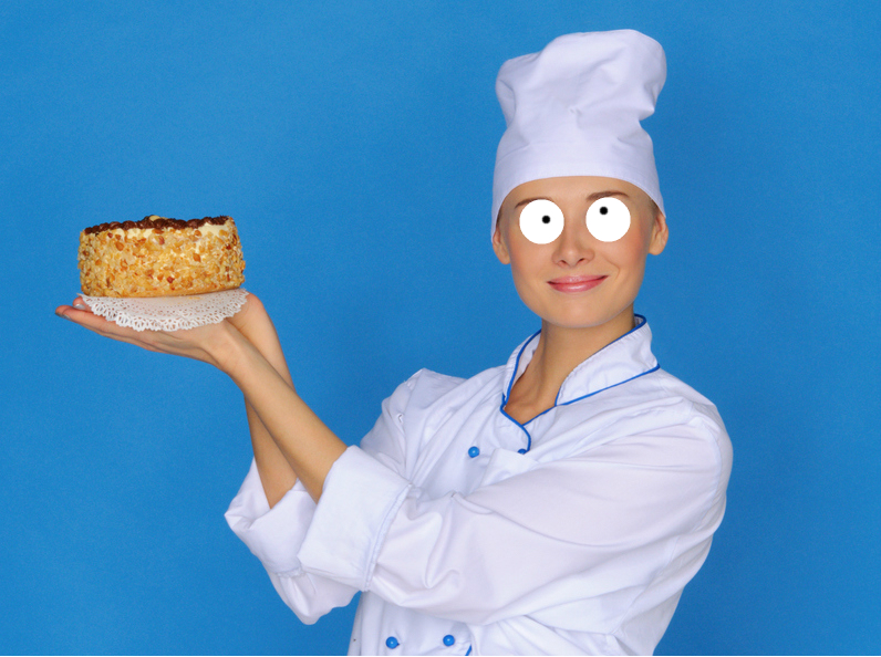 A baker holding a delicious cake