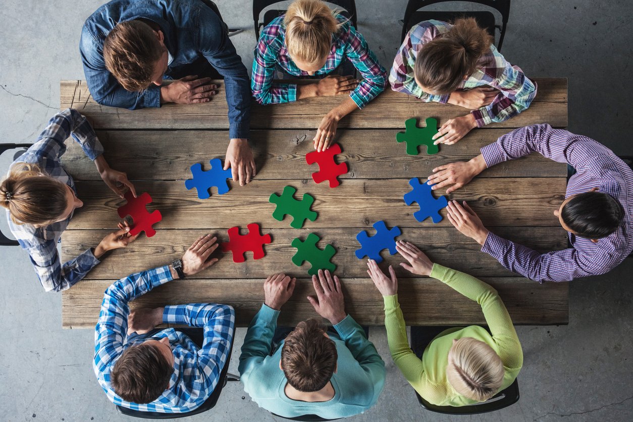 A group of people working out to do an easy jigsaw puzzle