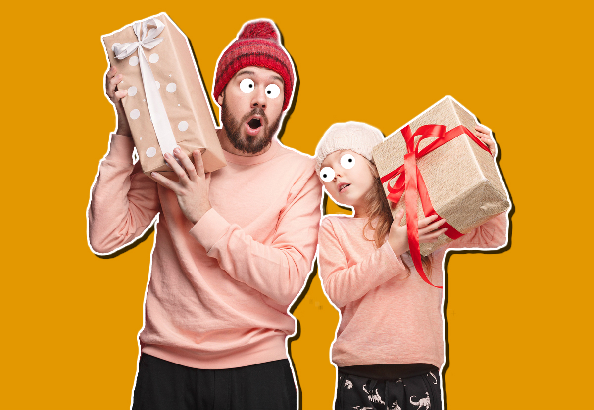 Two people holding big Christmas presents