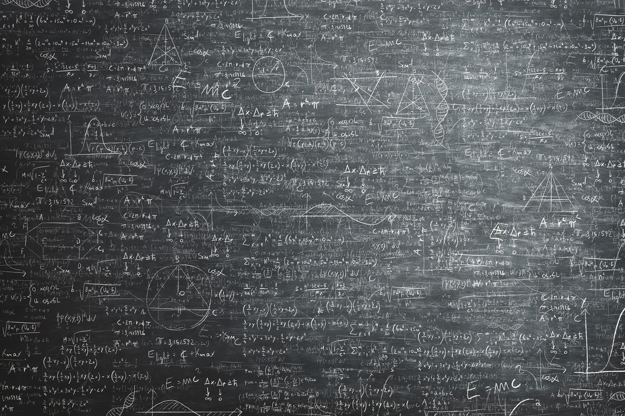 A chalk board covered in loads of maths