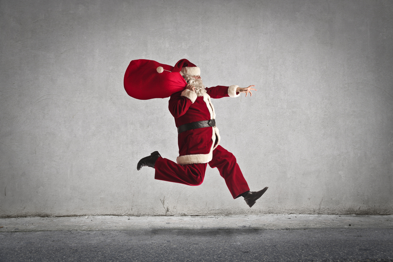 Santa leaping towards his sleigh