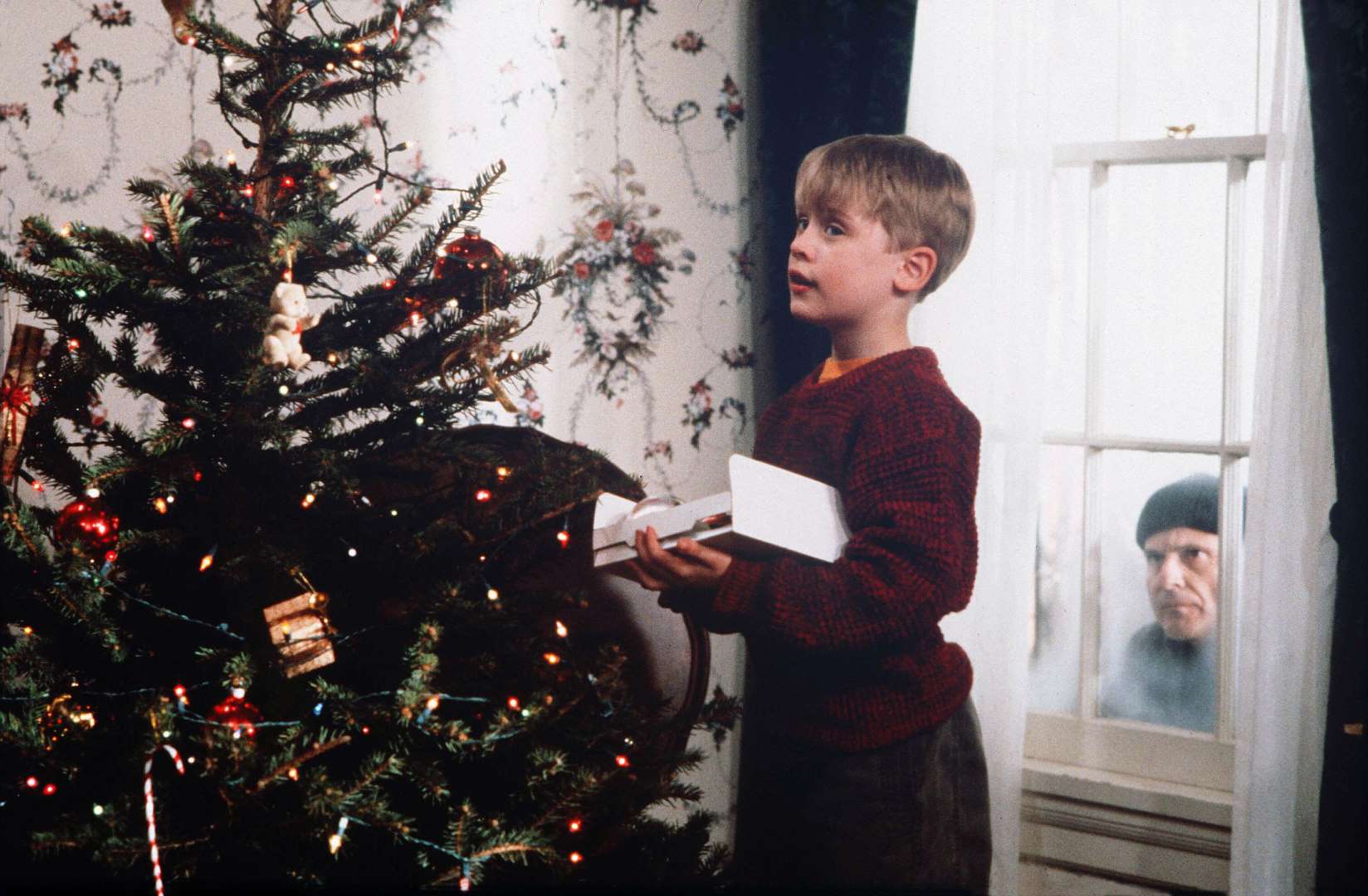 Home Alone – a burglar peers through the window of the McAllister house