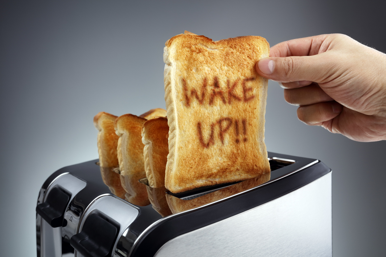 A piece of toast with 'Wake Up!' burned into it