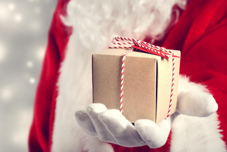 Santa holding a small gift