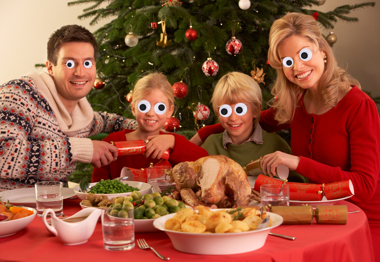 A family enjoying some Christmas crackers