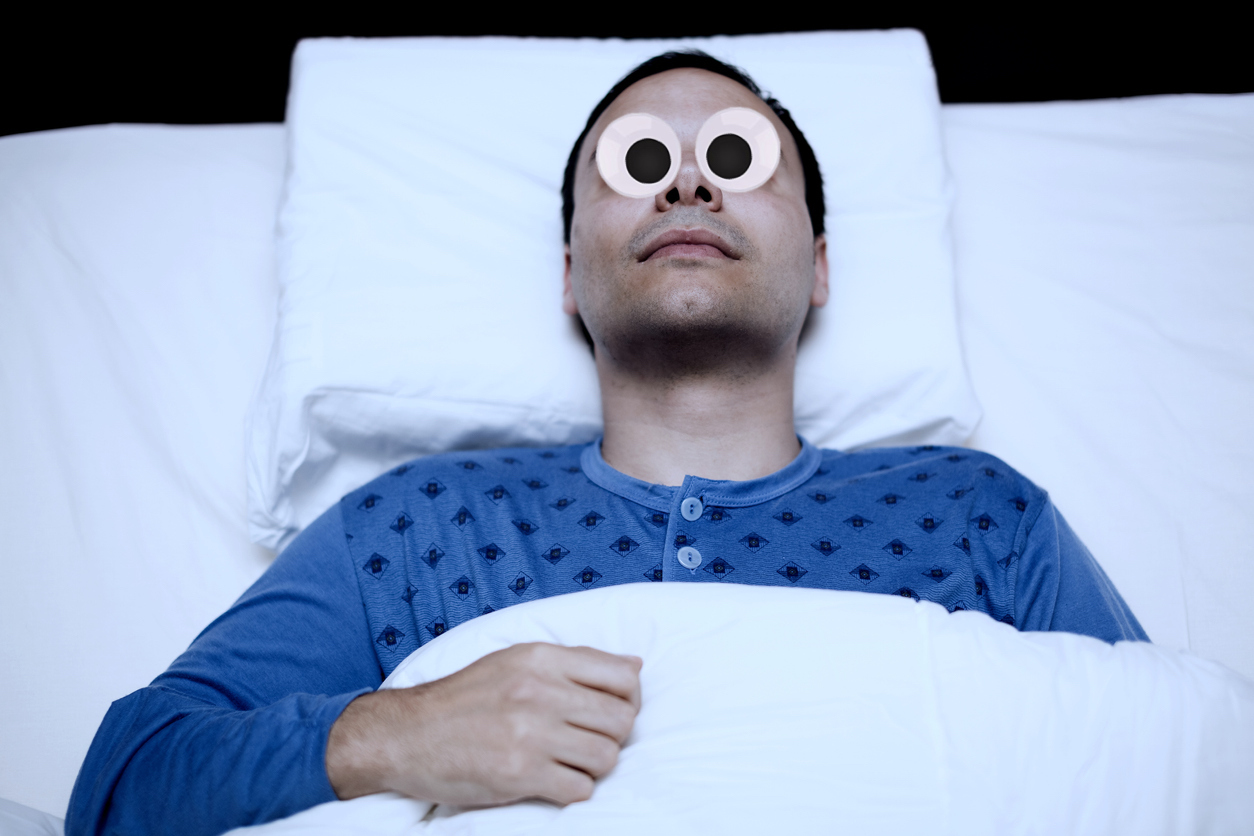 A person lying in bed wide awake