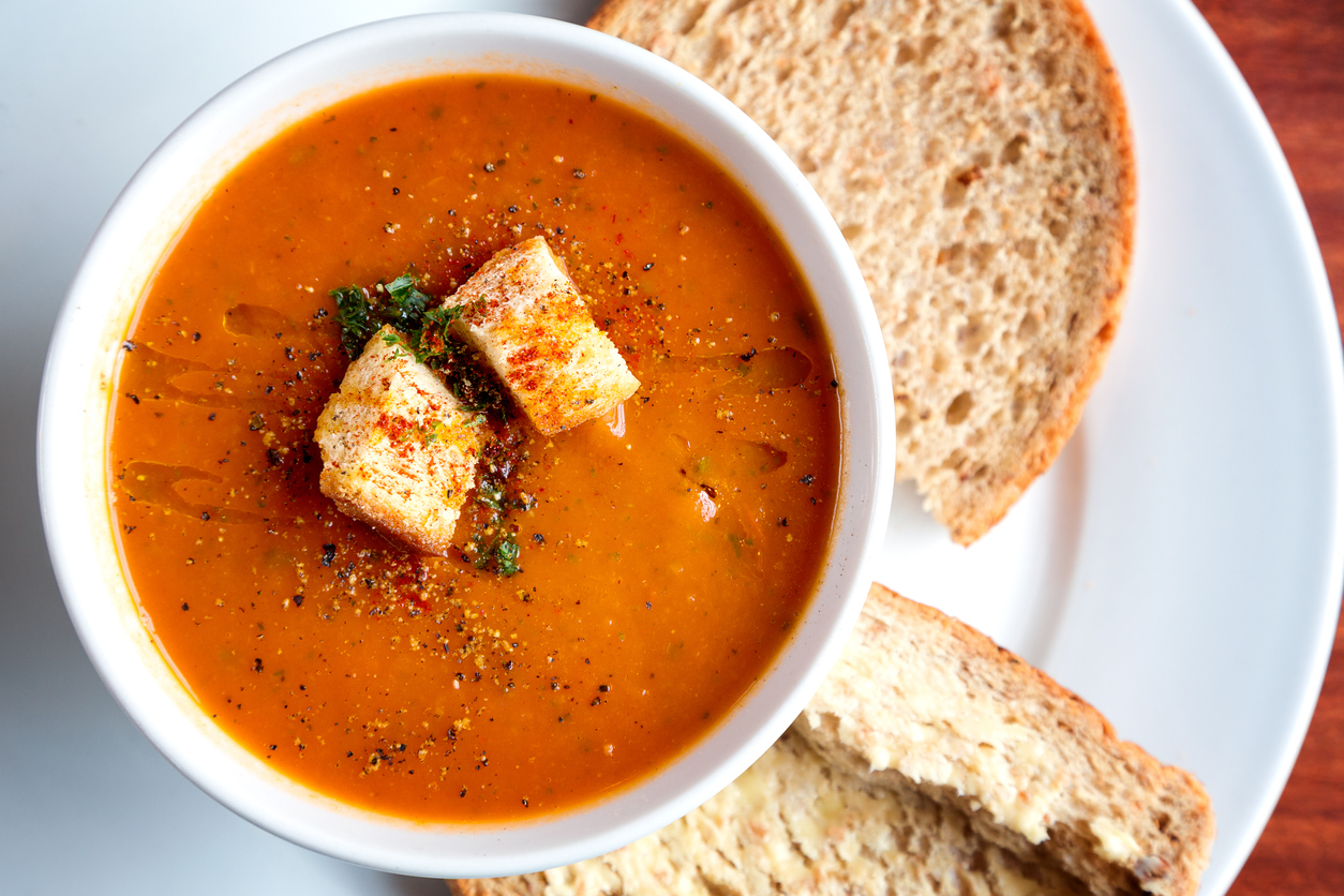 A big bowl of tomato soup and croutons 