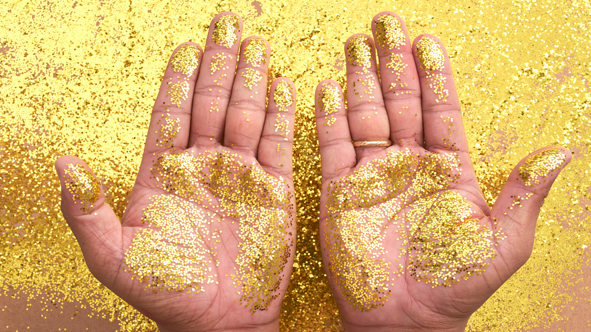 Hands with glitter all over them