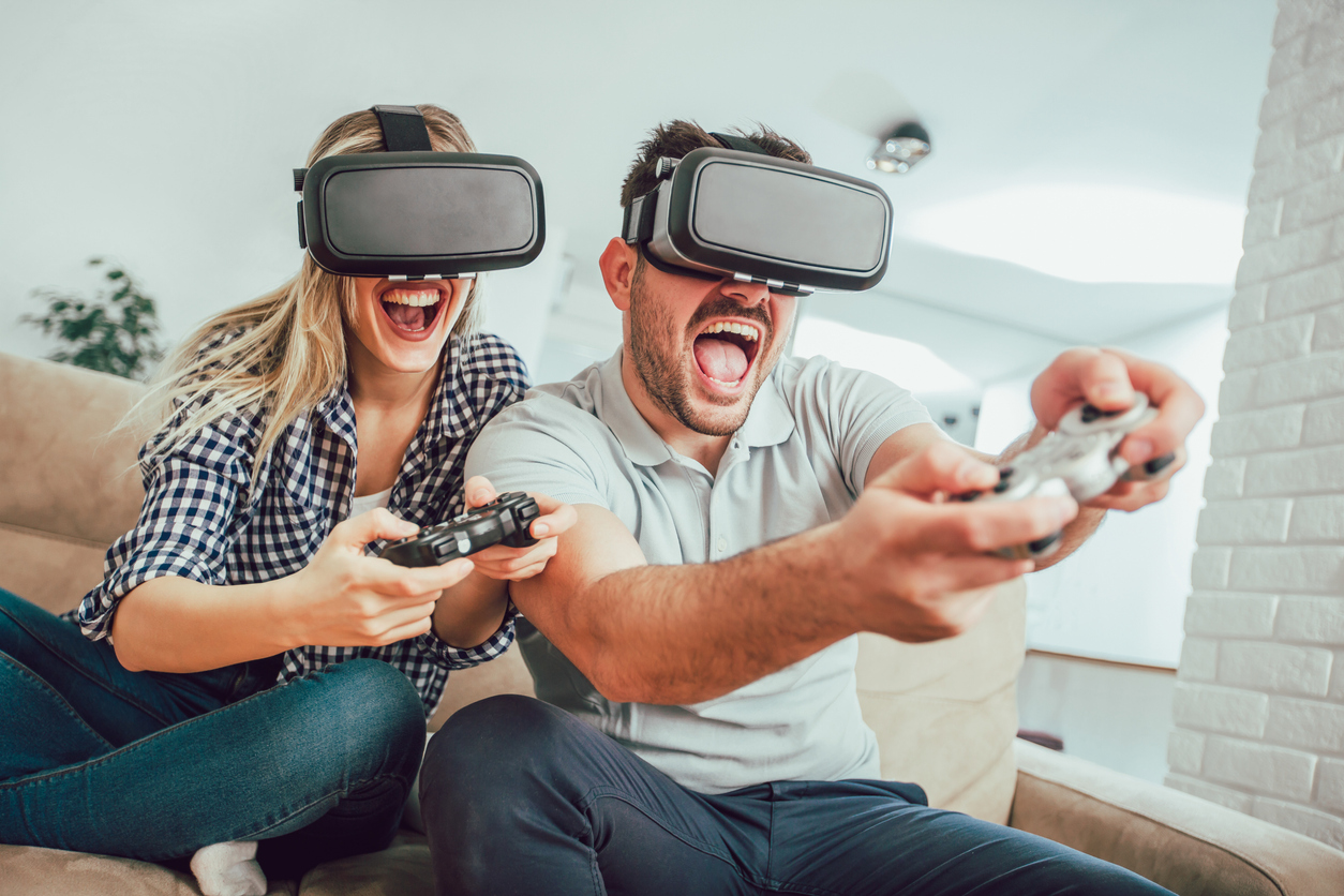A couple playing video games with VR headsets