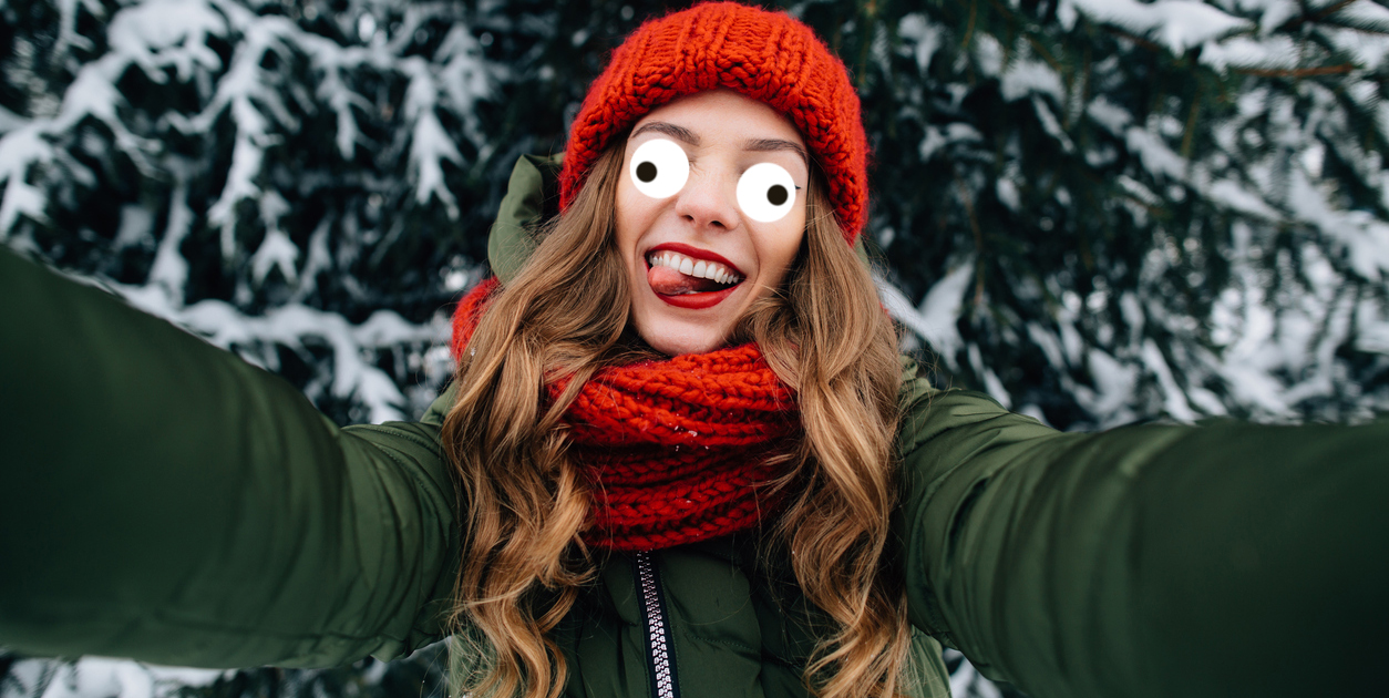 A young woman taking a selfie in the snow