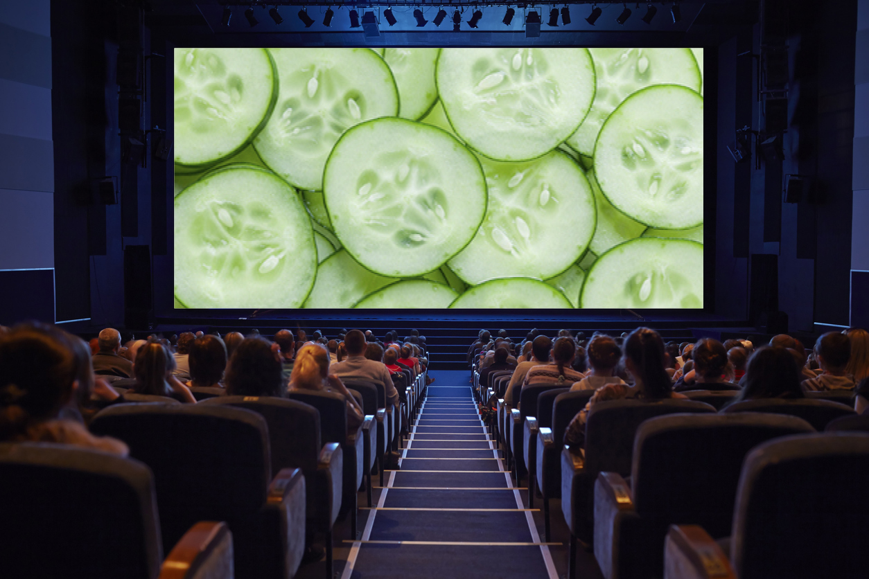 A cinema full of people watching slices of cucumber