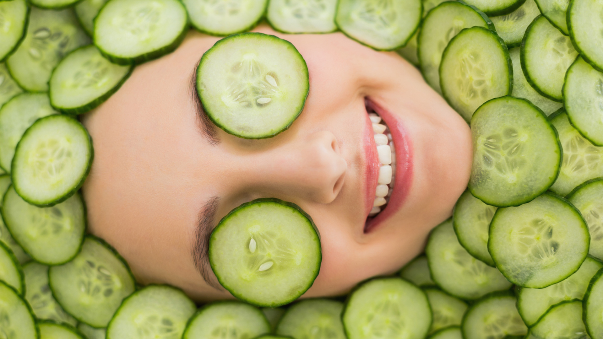 A woman relaxing with slices of cucumber over her eyes