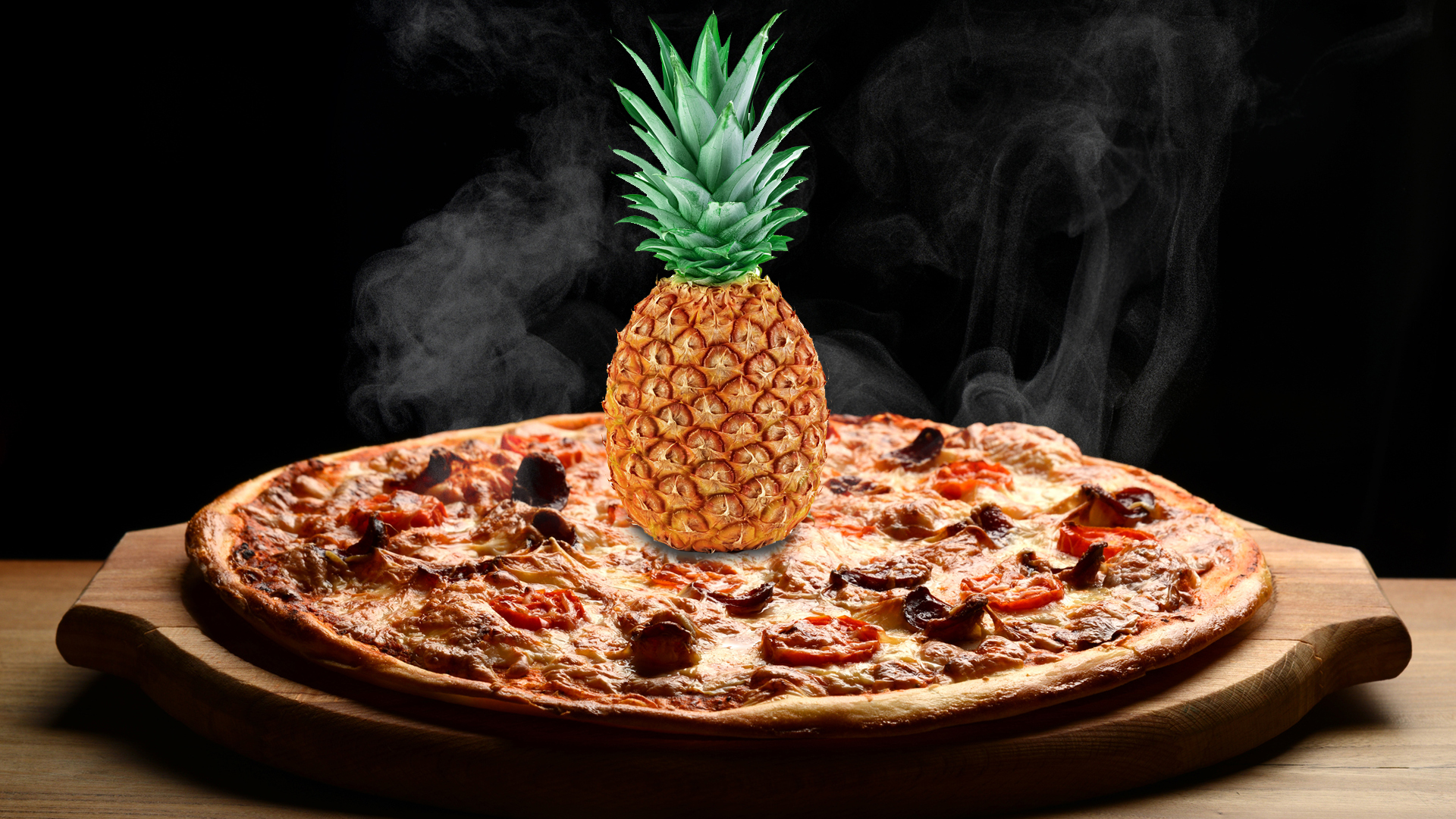 A whole pineapple sitting on a hot pizza