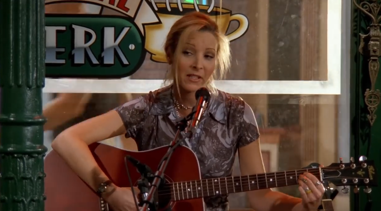 Phoebe playing guitar at Central Perk