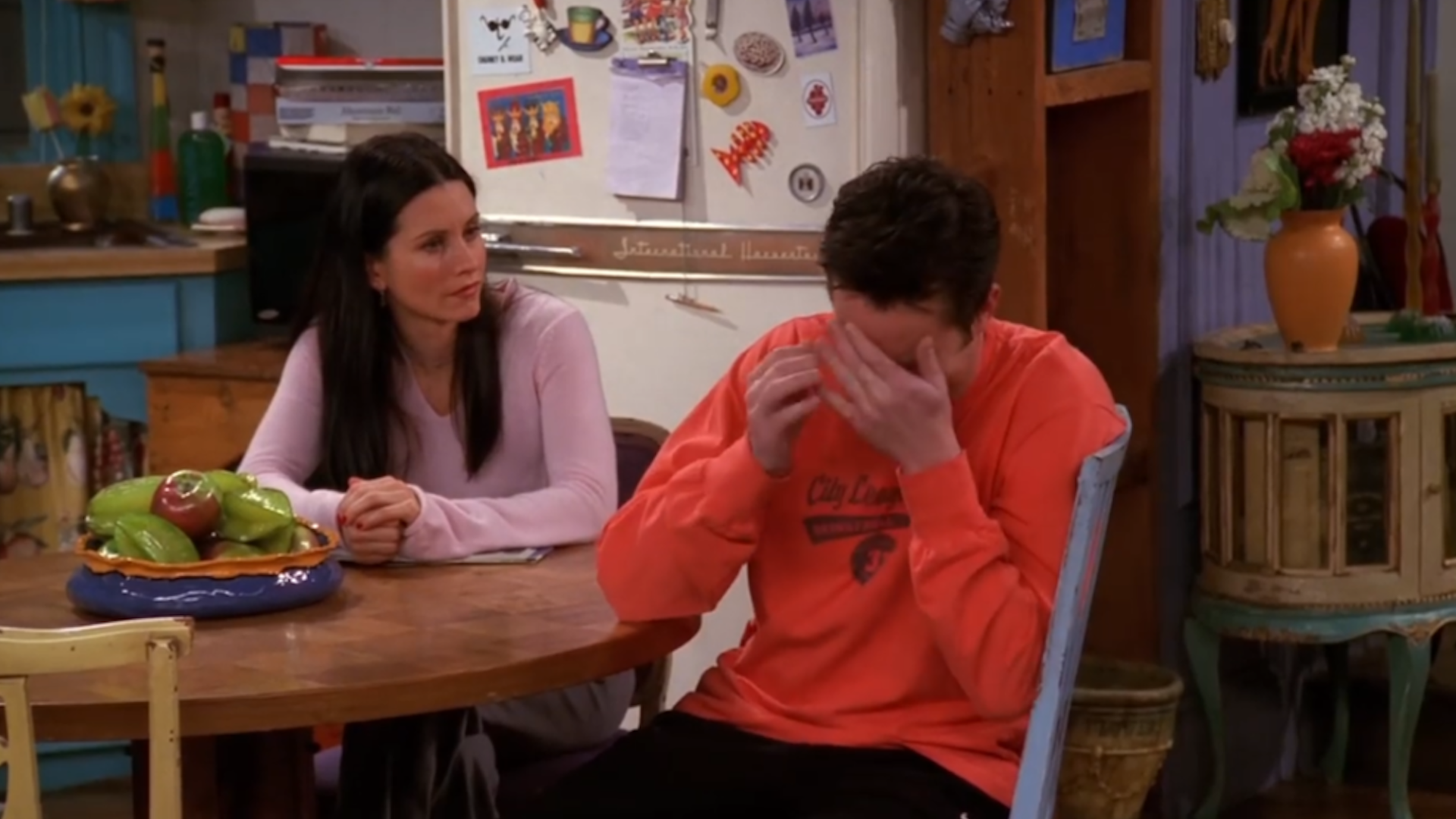 Chandler looks upset as Monica talks to him