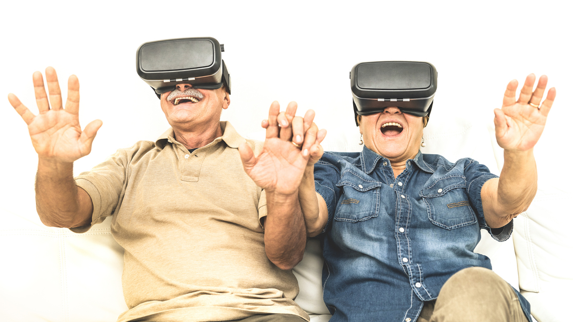 An elderly couple having fun together with virtual reality headset