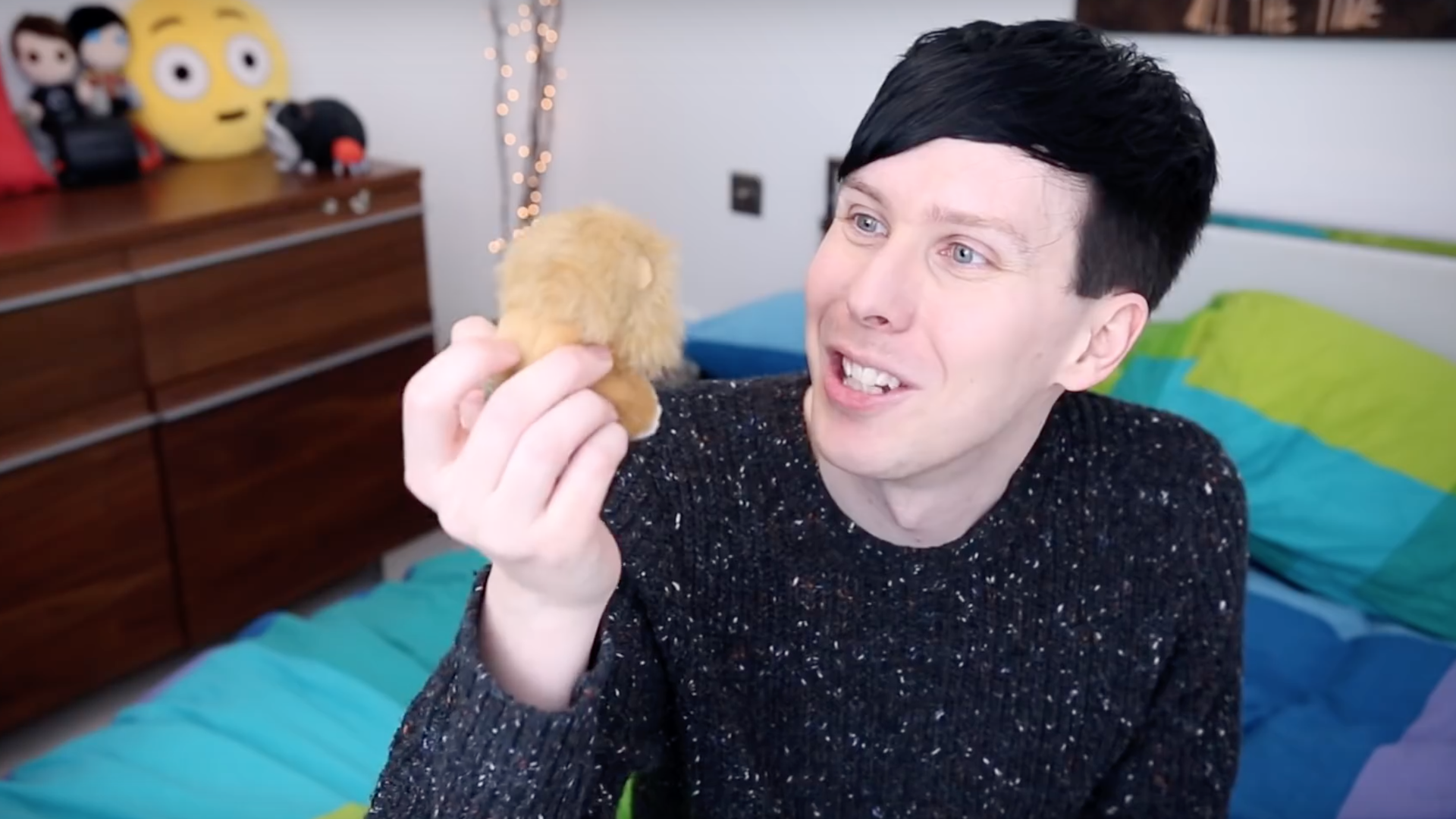 Dan holds up a toy lion