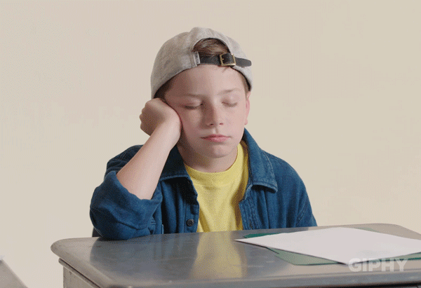 A child falling asleep at his desk