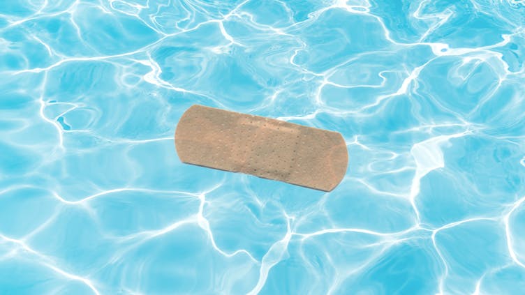 A used sticking plaster in a swimming pool