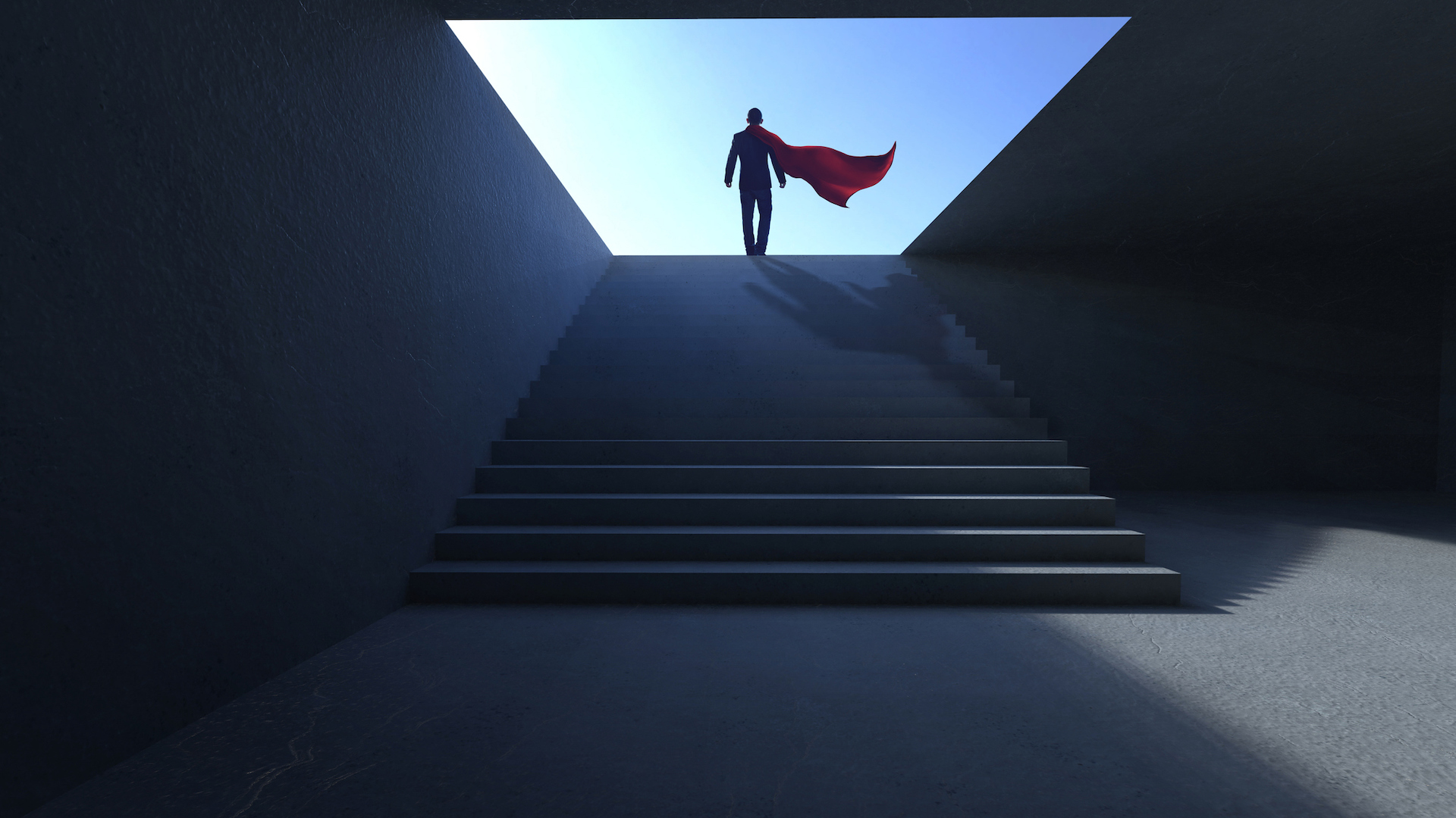 A man wearing a cape walking up stairs