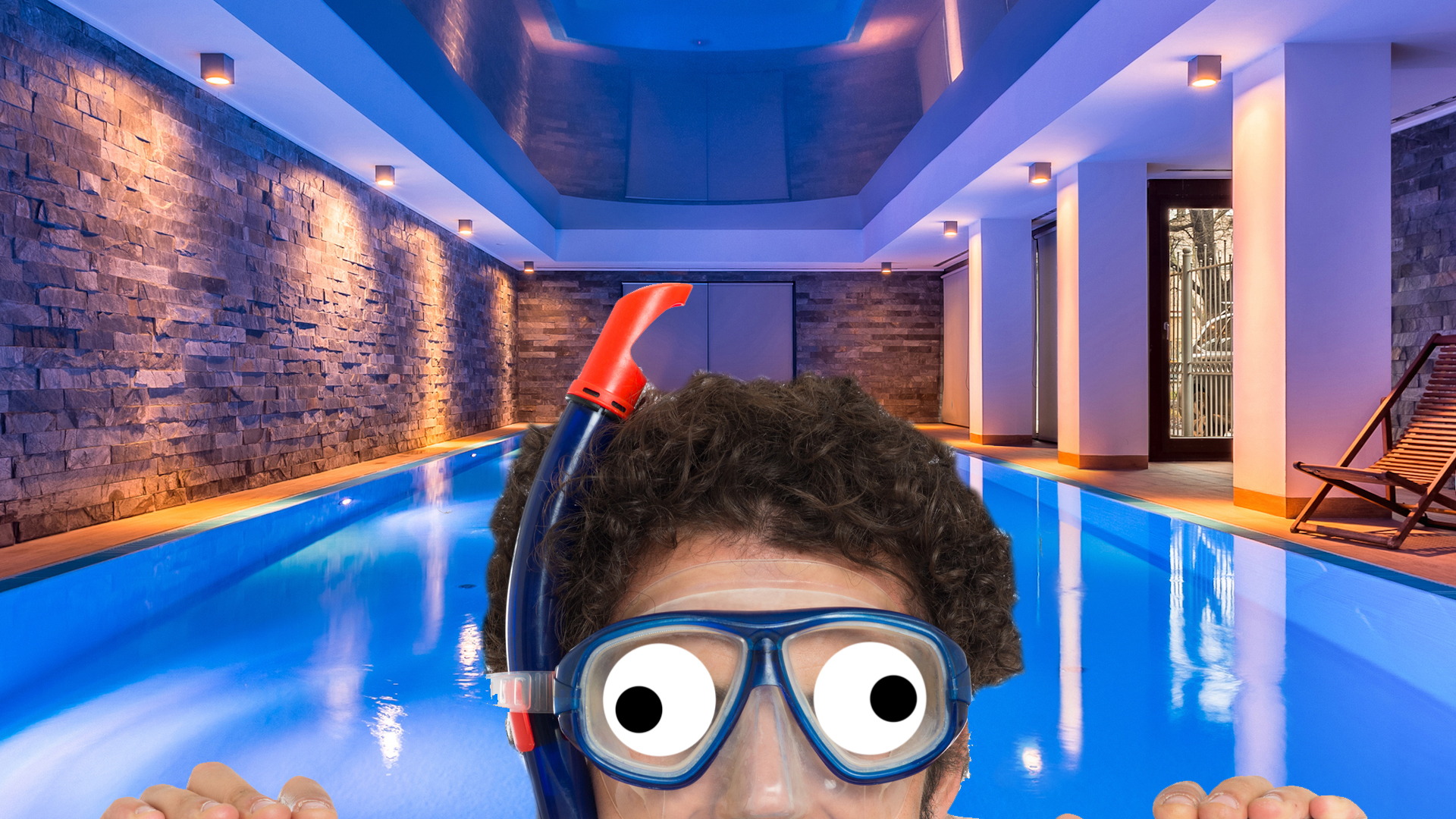A man in a snorkel at a fancy swimming pool