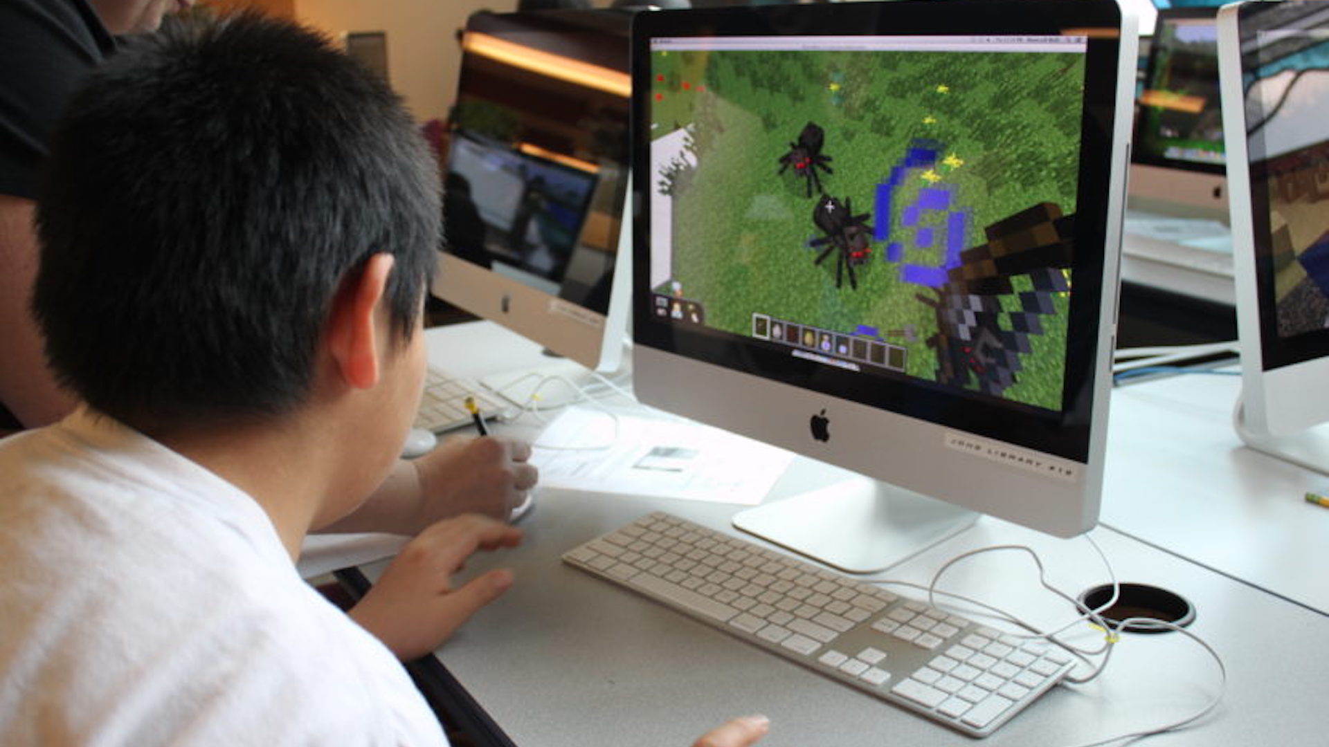 Someone playing Minecraft on a desktop computer