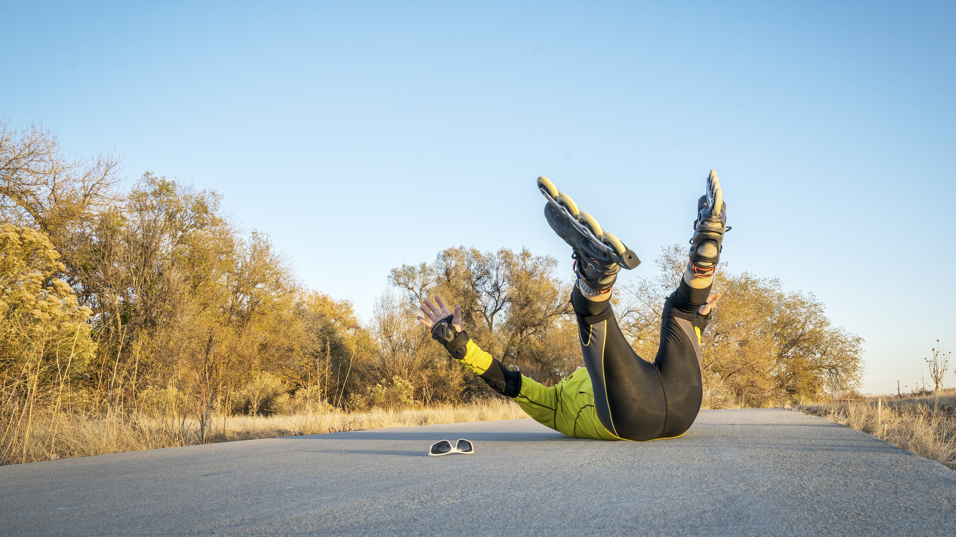 A person falling over during a rollerblading adventure 