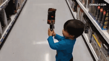 A child wielding a lightsaber in a toy shop