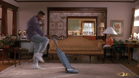 A man vacuuming the carpet
