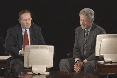 A former President laughing at a computer screen