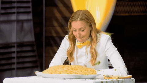 A young chef doused in  a load of yellow sauce 