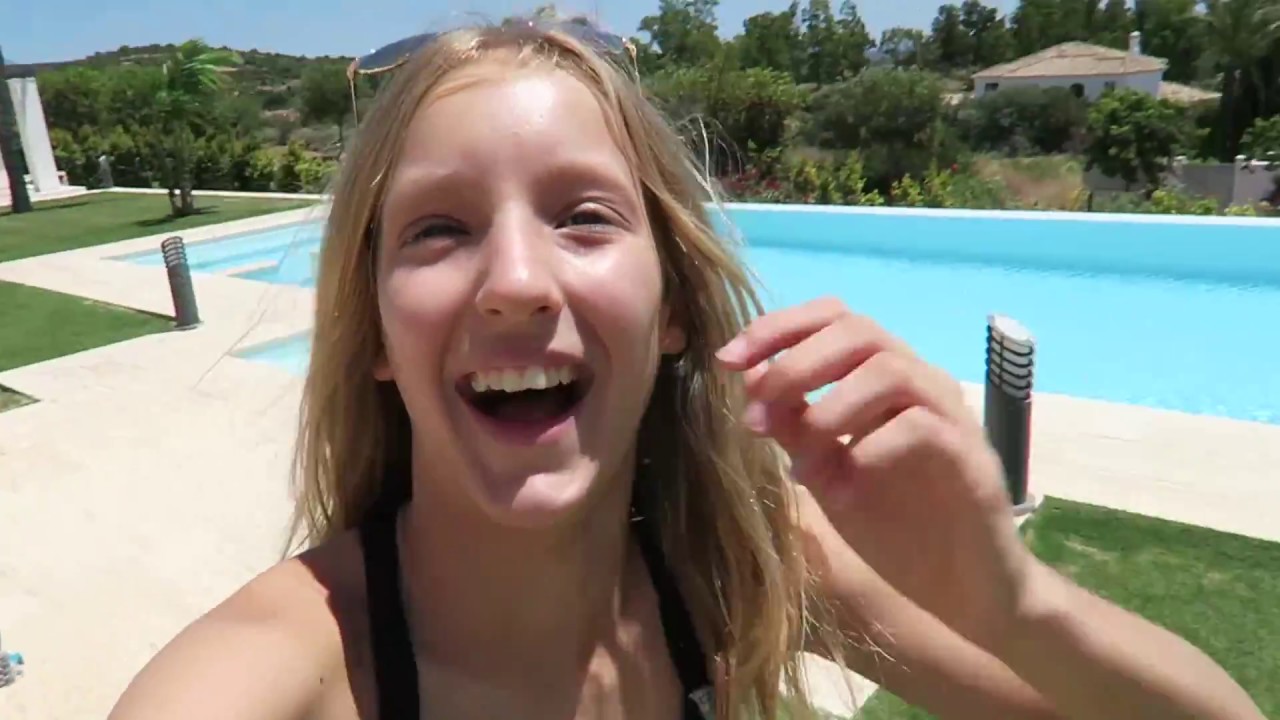 Karina next to an outdoor swimming pool