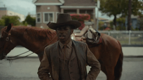 Lil Nas X dancing in front of a horse