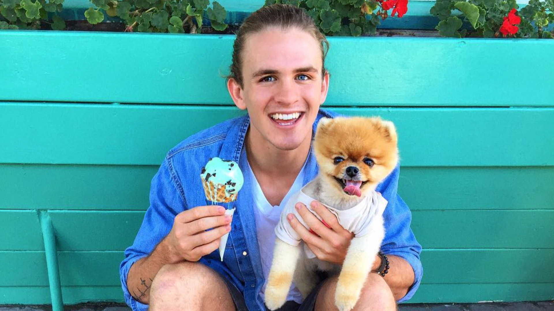 Cole LaBrant holding an ice cream and a small dog