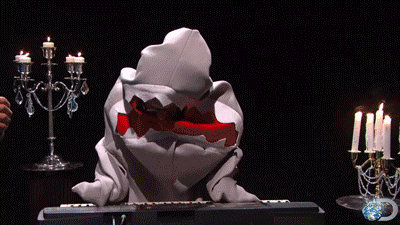 A man dressed as a shark playing the piano