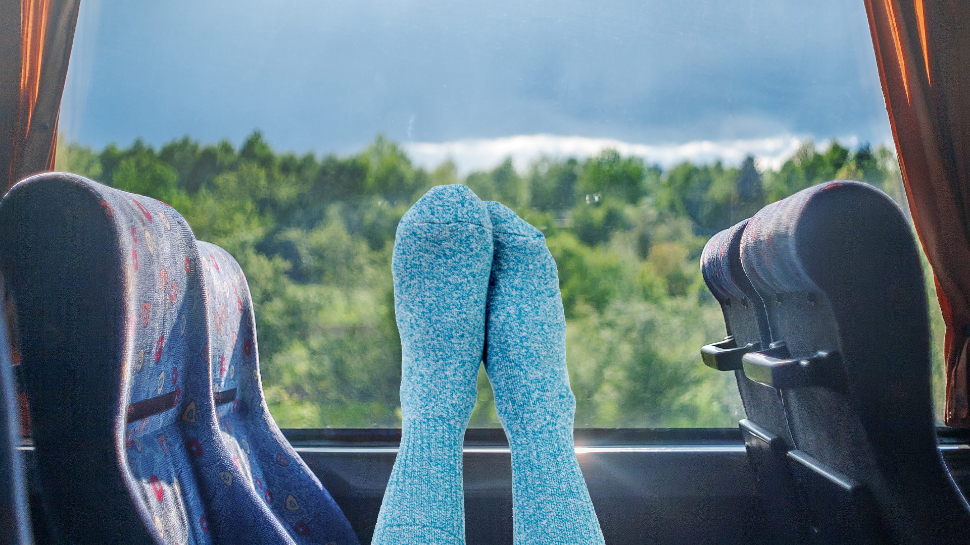 A pair of feet in socks relaxing on a bus