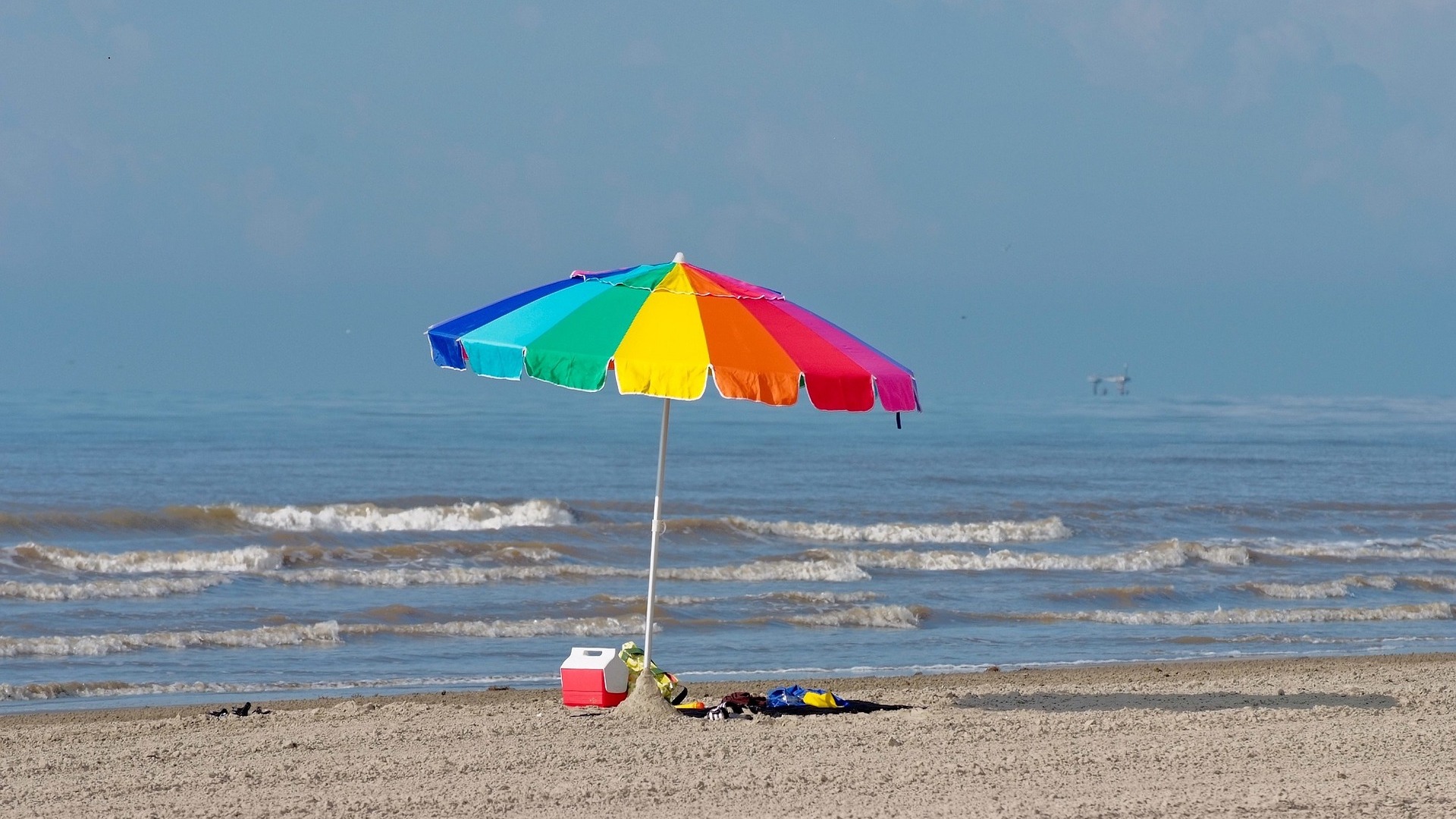 A beach and parasol 