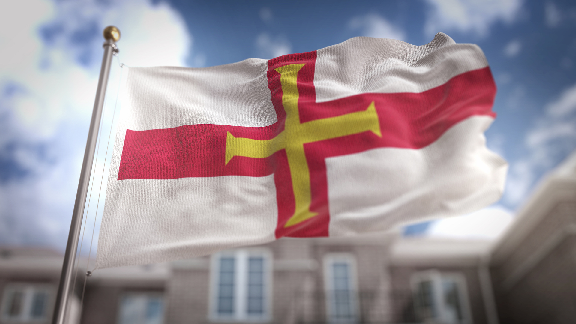 A Guernsey flag fluttering in the wind