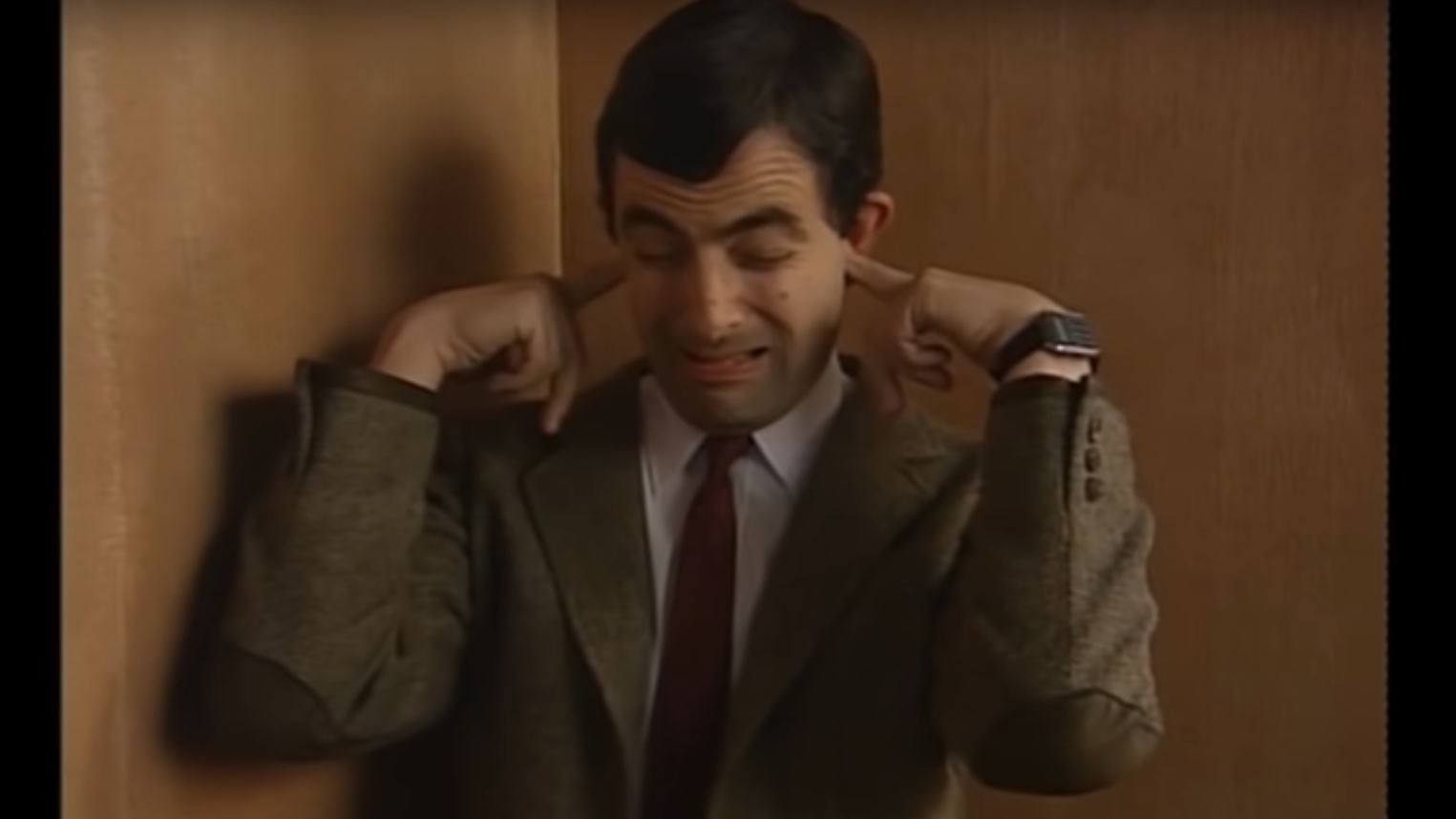 Mr Bean with his fingers in his ears